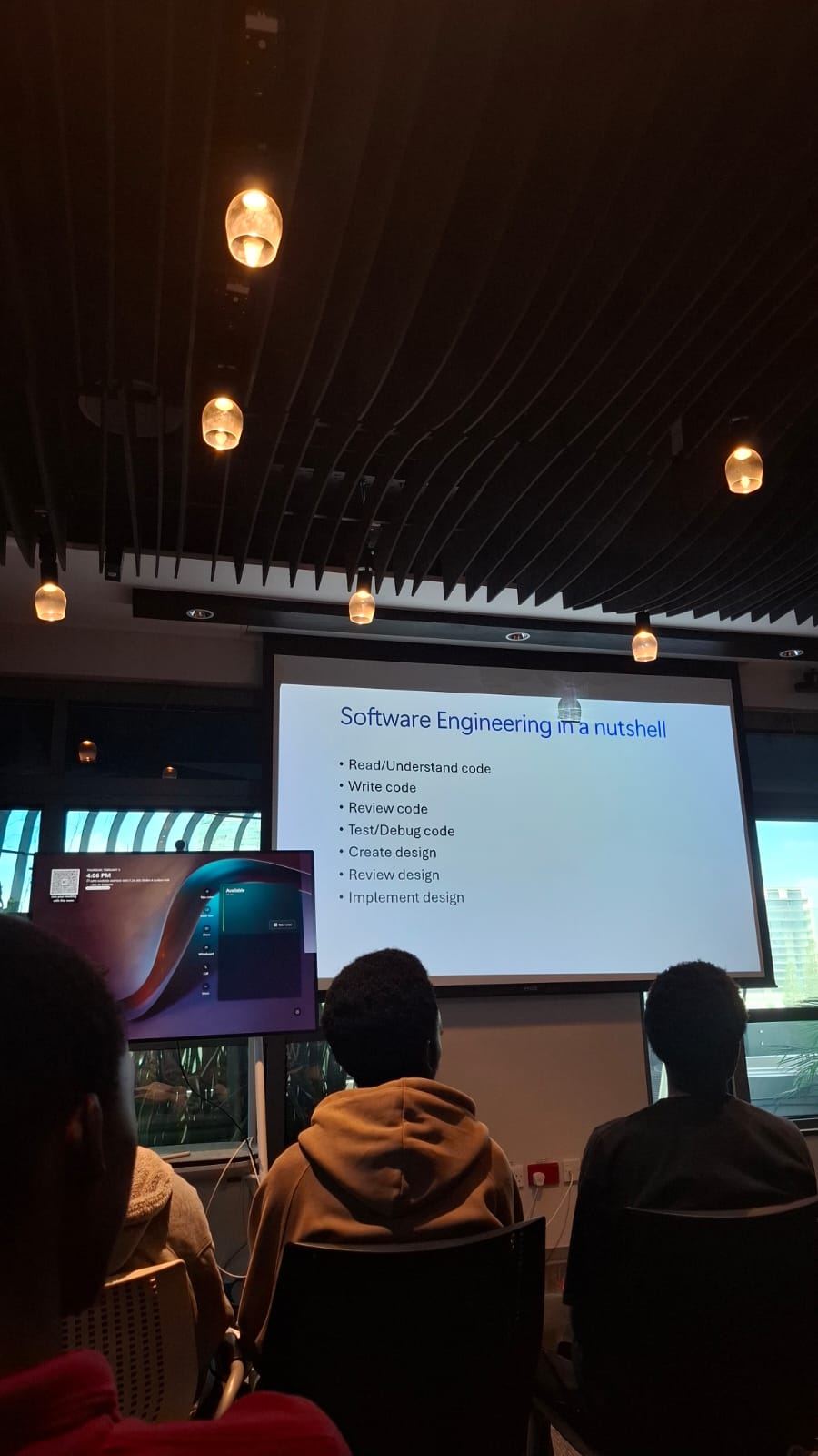 Presentation slide titled Software Engineering in a nutshell, covering reading, writing, reviewing, testing, and designing code